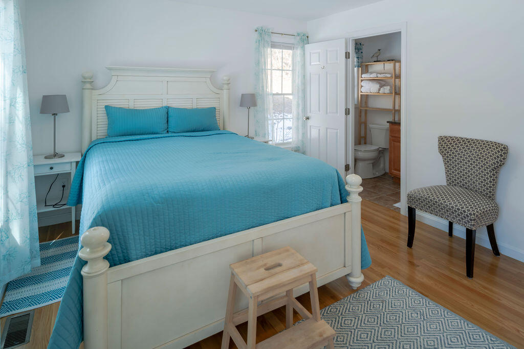 45 Perch Pond Way Wellfleet, MA 02667 - Photo 35 of 82 a bedroom with a bed and a chair