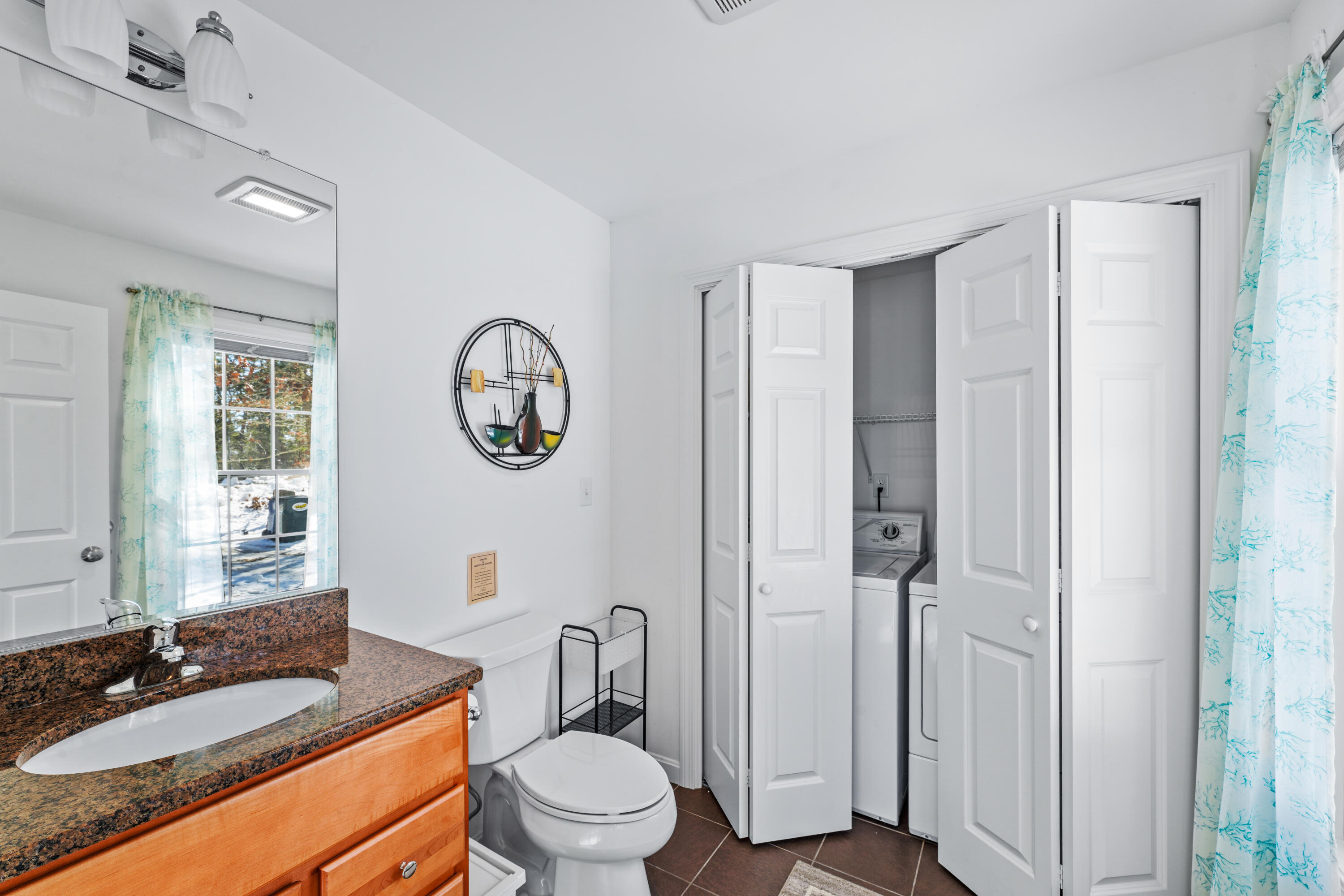 45 Perch Pond Way Wellfleet, MA 02667 - Photo 48 of 82 a bathroom with a granite countertop toilet a sink and a mirror