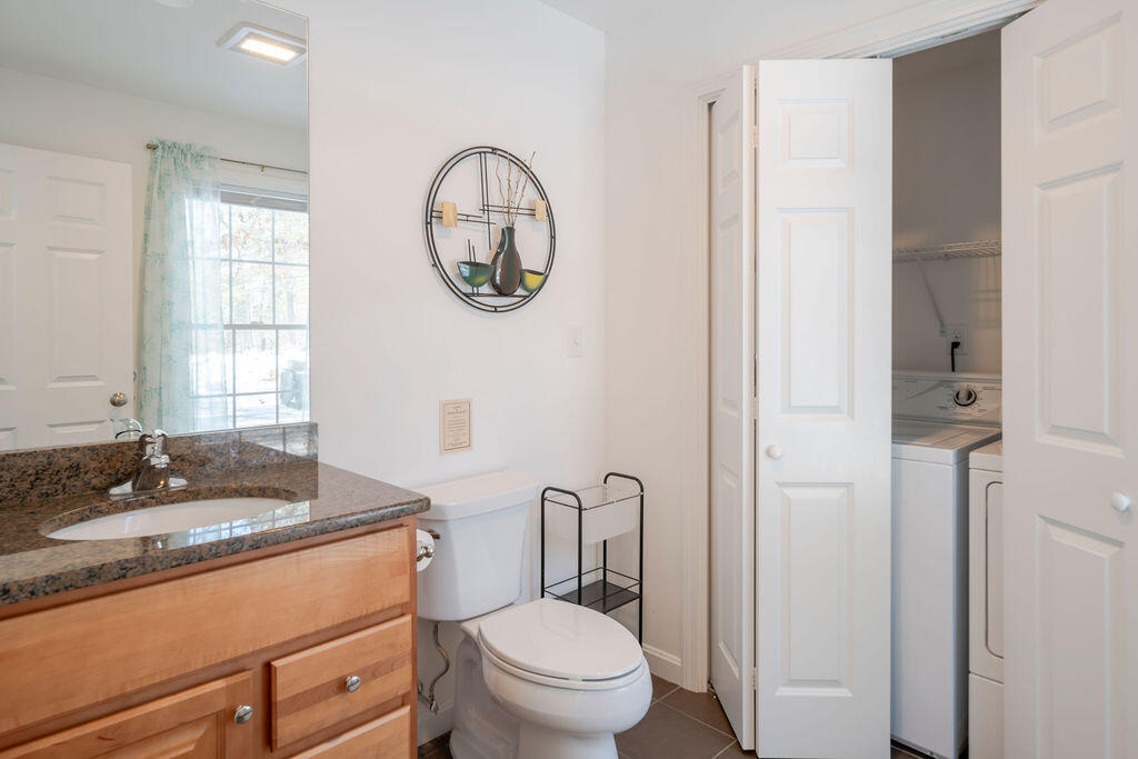 45 Perch Pond Way Wellfleet, MA 02667 - Photo 57 of 82 a bathroom with a granite countertop toilet a sink and a mirror