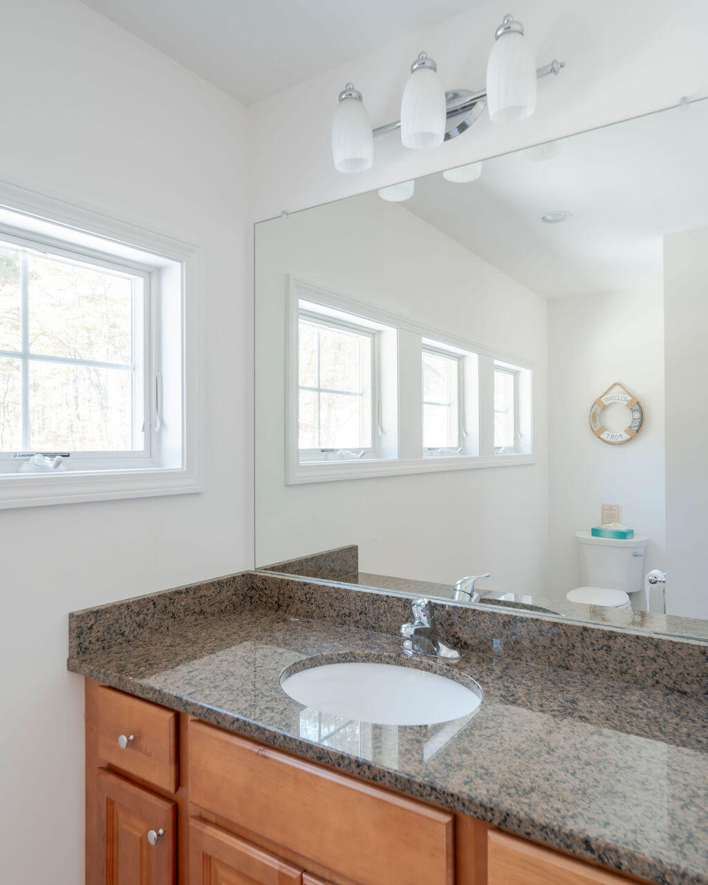45 Perch Pond Way Wellfleet, MA 02667 - Photo 63 of 82 a bathroom with a granite countertop sink and a window