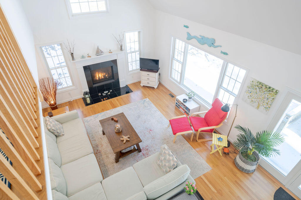 45 Perch Pond Way Wellfleet, MA 02667 - Photo 8 of 82 a living room with furniture and a fireplace