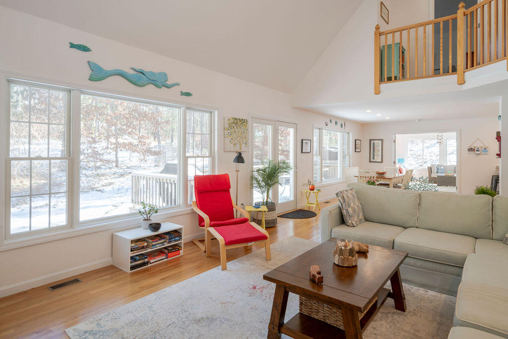 45 Perch Pond Way Wellfleet, MA 02667 - Photo 9 of 82 a living room with furniture a table and a large window