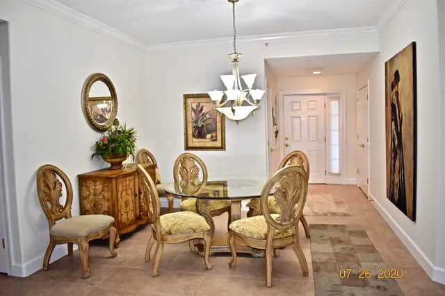 a view of a dining room with furniture and chandelier