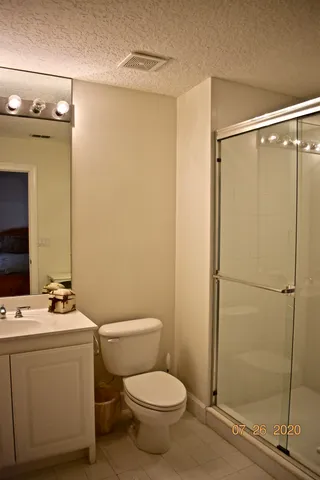 a white toilet sitting next to a bathroom sink