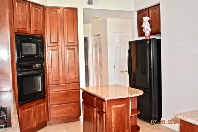 a kitchen with stainless steel appliances a refrigerator and microwave