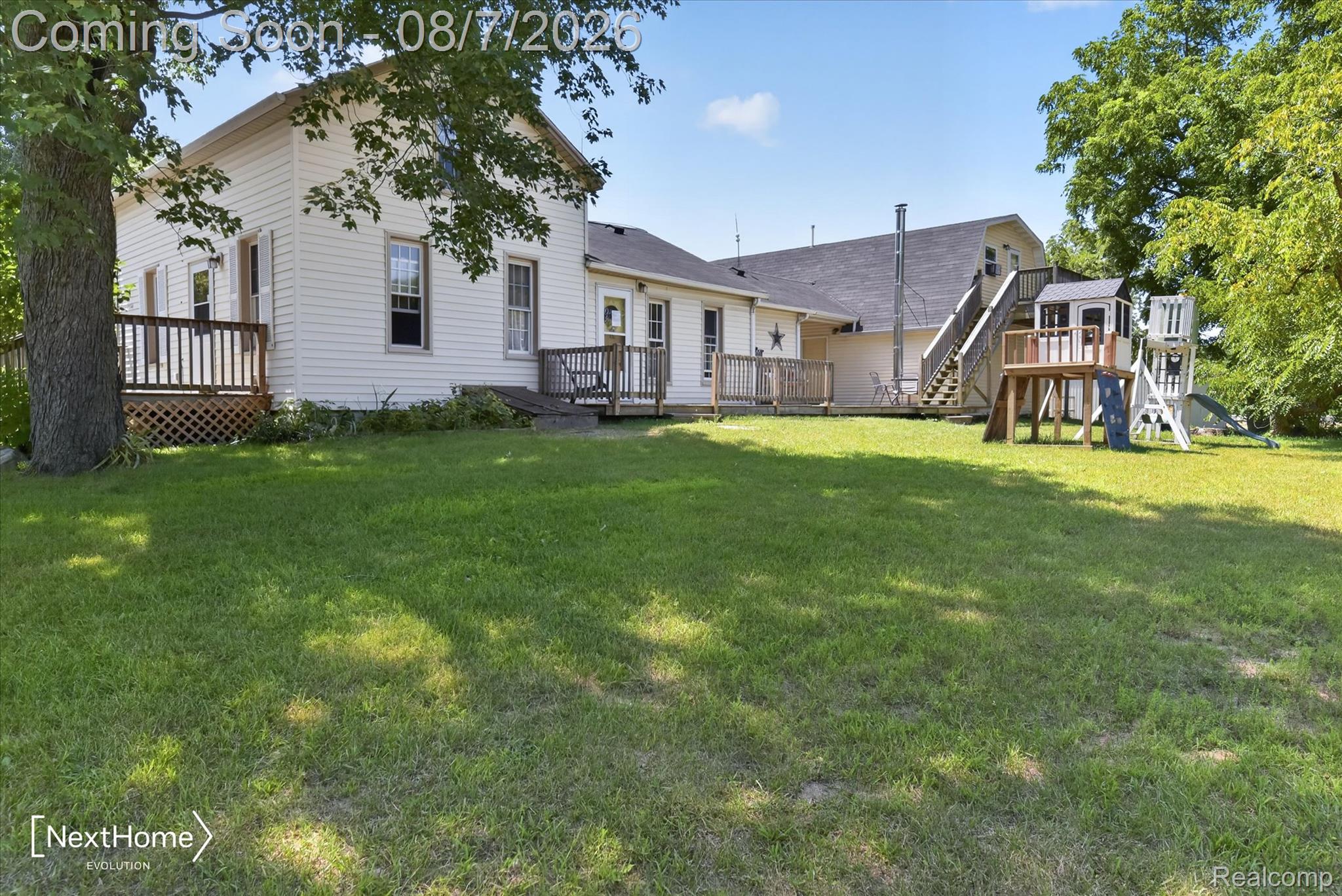 23740 Carleton West Road Belleville, MI 48111 - Photo 2 of 58 Charming farmhouse-style residence with expansive grounds featuring a manicured lawn, mature shade trees, and multiple outbuildings