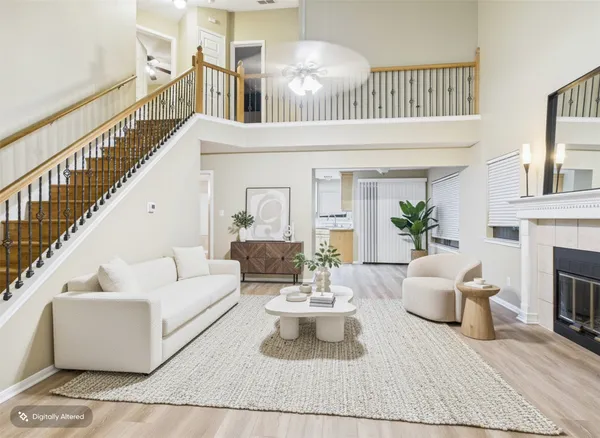 a living room with furniture a fireplace and a chandelier