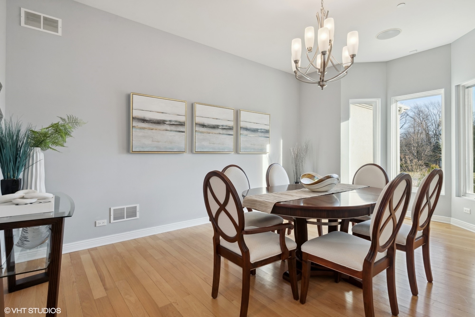 1853 Checker Road Long Grove, IL 60047 - Photo 11 of 63 a view of a dining room with furniture a chandelier and wooden floor