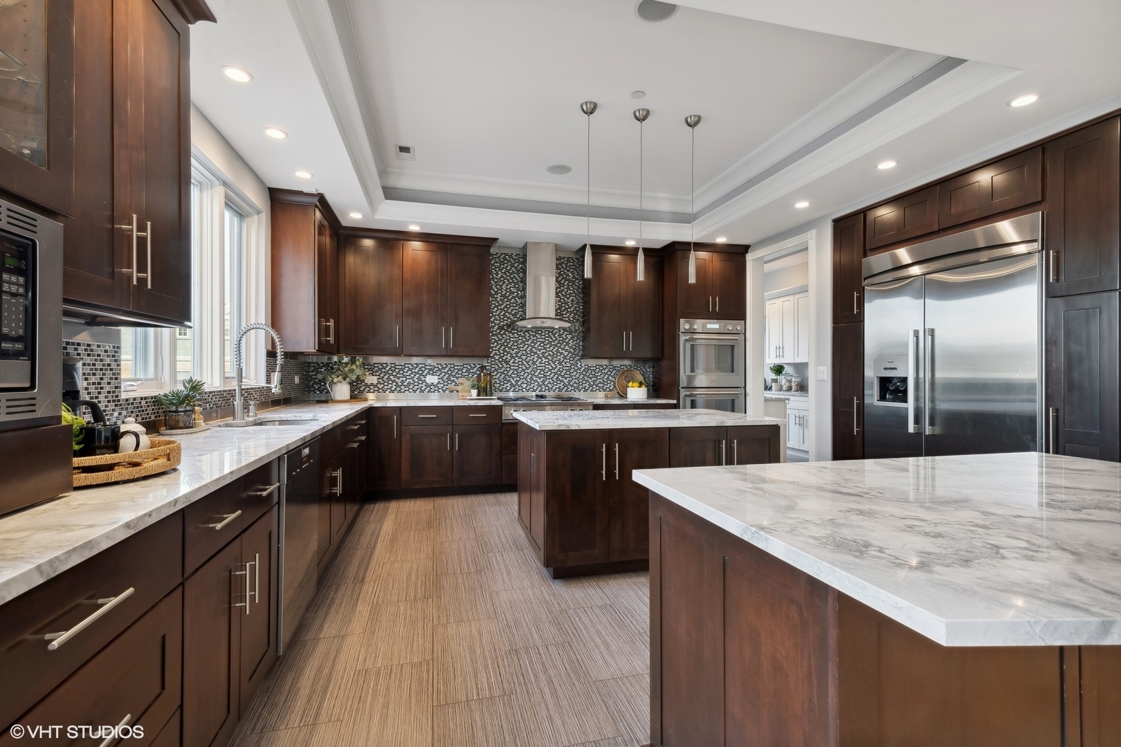 1853 Checker Road Long Grove, IL 60047 - Photo 15 of 63 a large kitchen with kitchen island a large counter space a sink appliances and cabinets