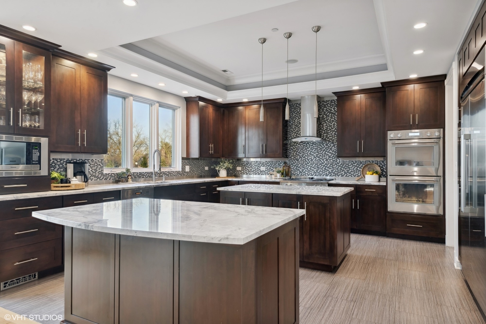 1853 Checker Road Long Grove, IL 60047 - Photo 16 of 63 a large kitchen with granite countertop a large counter top stainless steel appliances and cabinets
