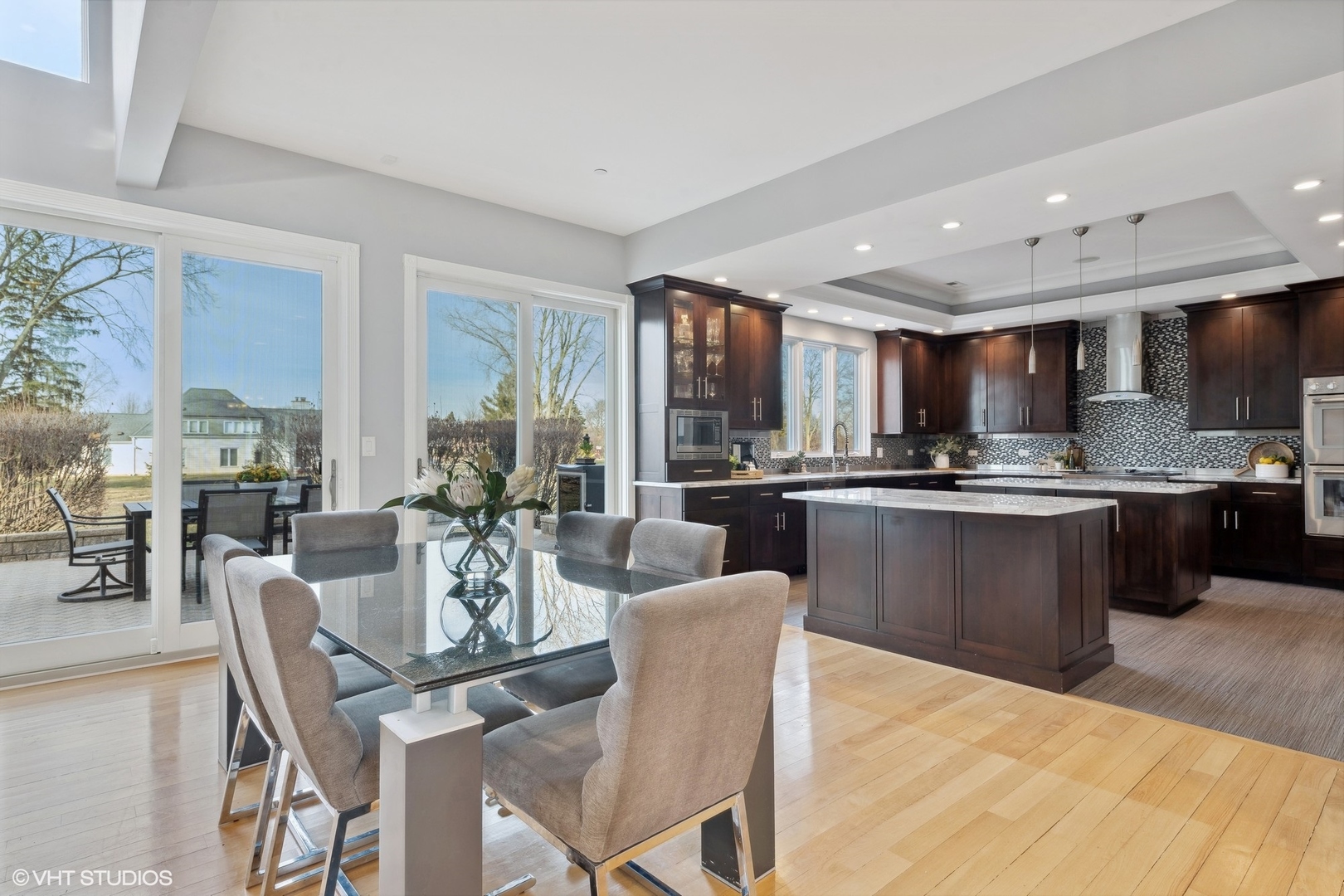 1853 Checker Road Long Grove, IL 60047 - Photo 24 of 63 a kitchen with a dining table chairs stainless steel appliances and cabinets