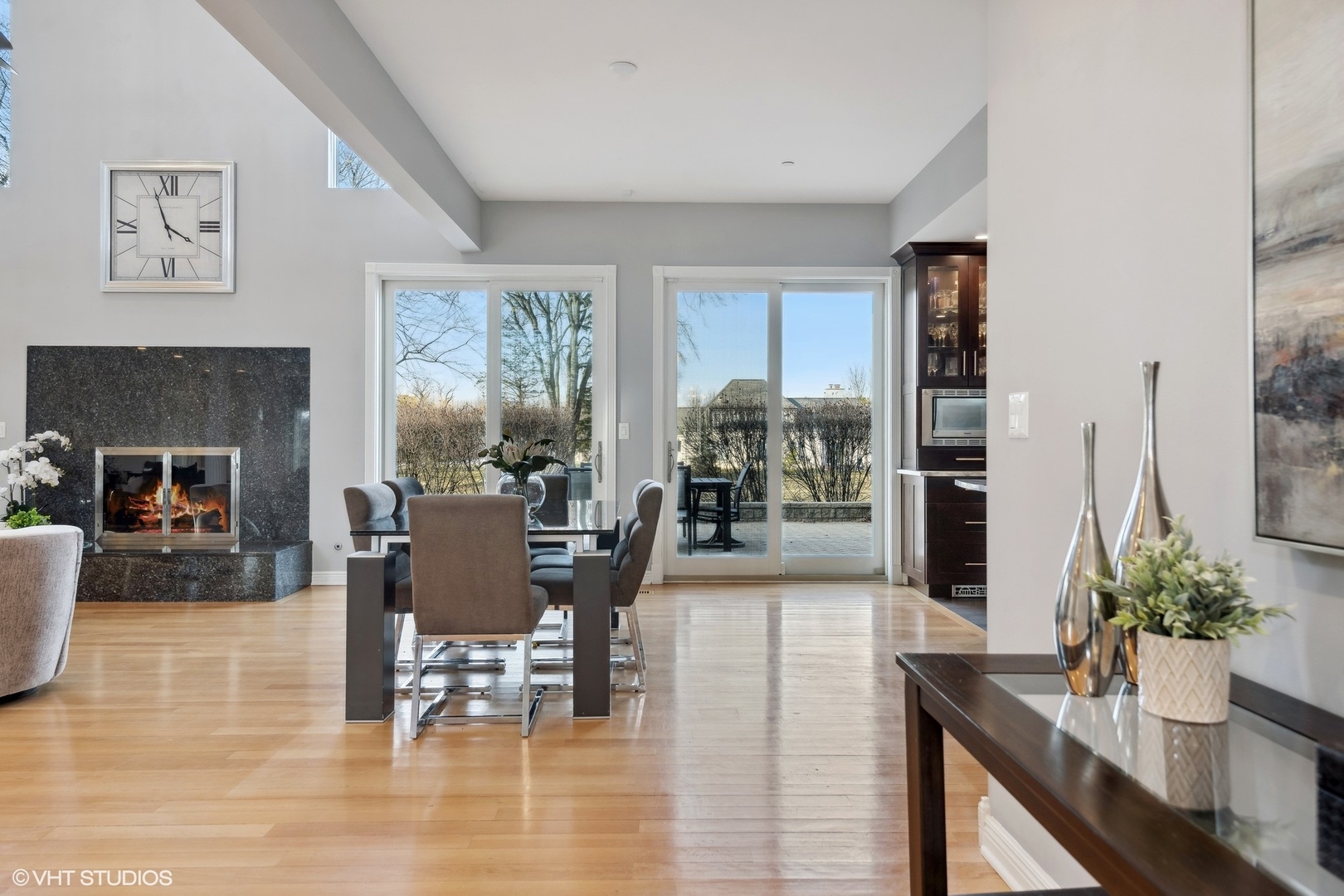 1853 Checker Road Long Grove, IL 60047 - Photo 25 of 63 a dining room with furniture potted plants and wooden floor