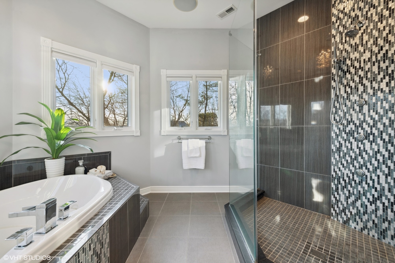 1853 Checker Road Long Grove, IL 60047 - Photo 37 of 63 a bathroom with a tub a sink and glass door shower
