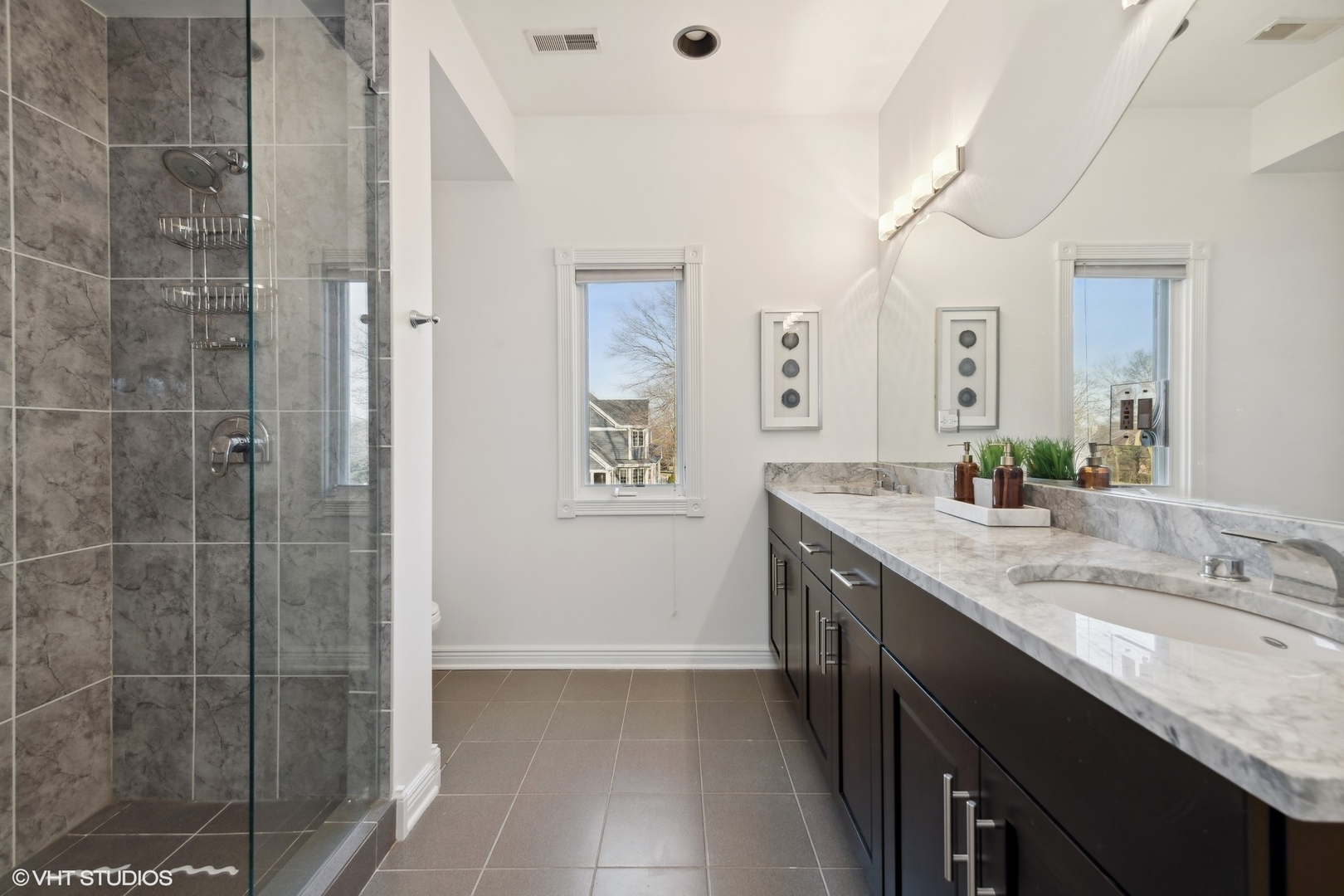 1853 Checker Road Long Grove, IL 60047 - Photo 43 of 63 a bathroom with a granite countertop sink a shower and a mirror