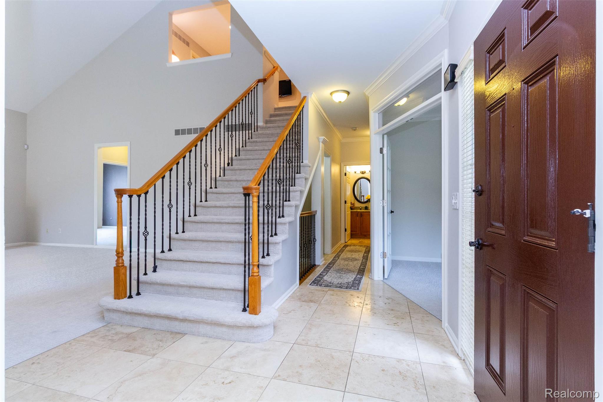3805 Windingbrook Circle, Unit 22 Rochester, MI 48309 - Photo 9 of 63 Foyer featuring light carpet, crown molding, and a high ceiling