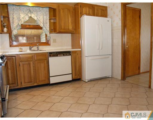 1112 New Dover Road Edison, NJ 08820 - Photo 17 of 25 a white refrigerator freezer sitting in a kitchen