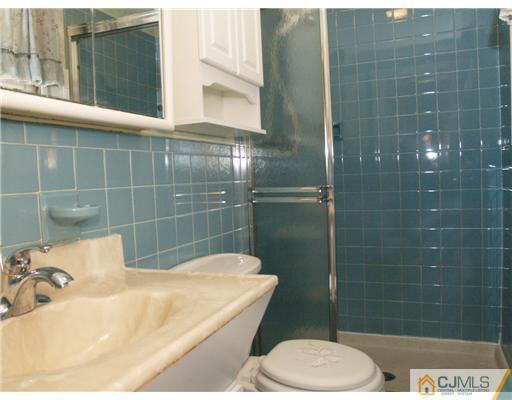 1112 New Dover Road Edison, NJ 08820 - Photo 6 of 25 a bathroom with a sink toilet and shower