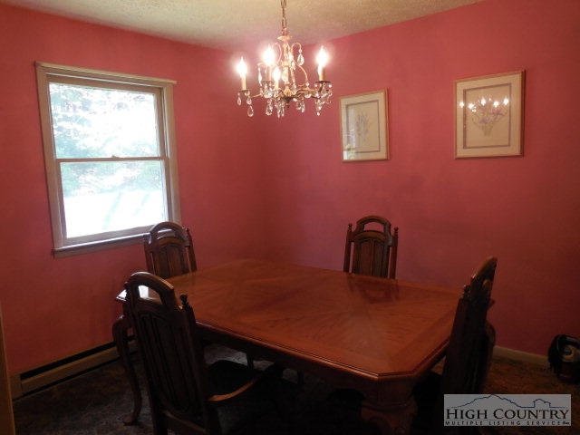 1310 Ben Miller Road Deep Gap, NC 28618 - Photo 4 of 22 a view of a dining room with furniture and chandelier