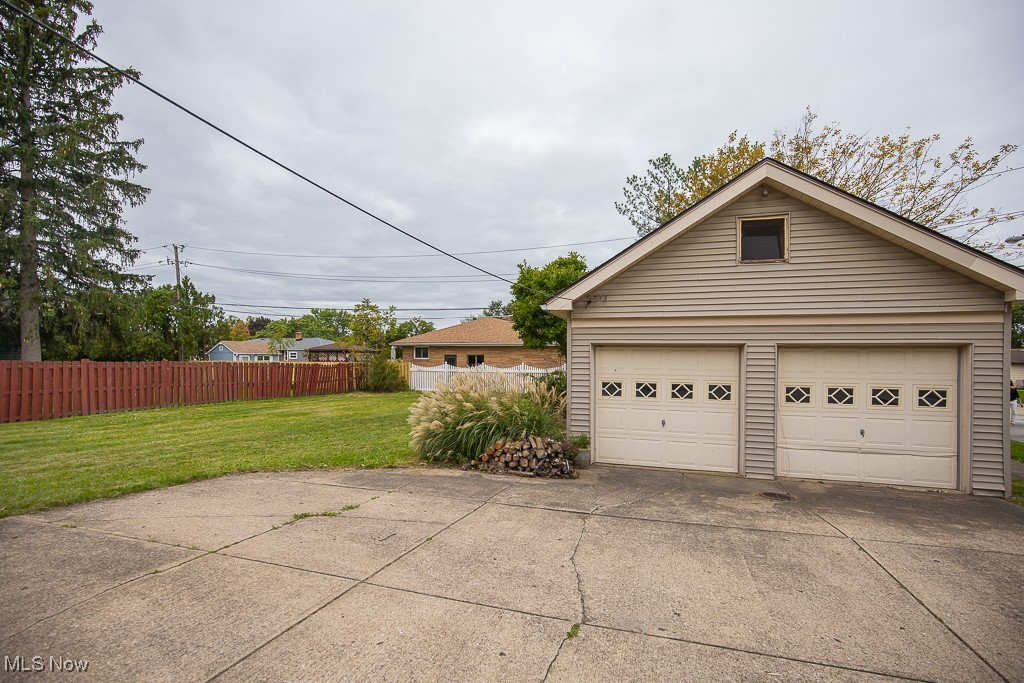 7070 Ridge Road Parma, OH 44129 - Photo 28 of 28 Garage featuring a lawn