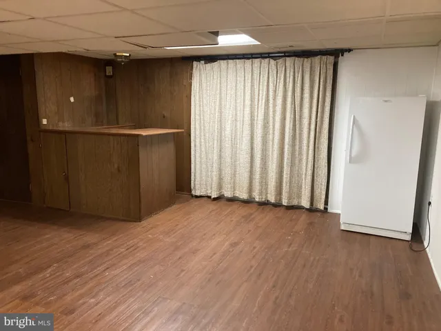 a view of an empty room with a fireplace and a window