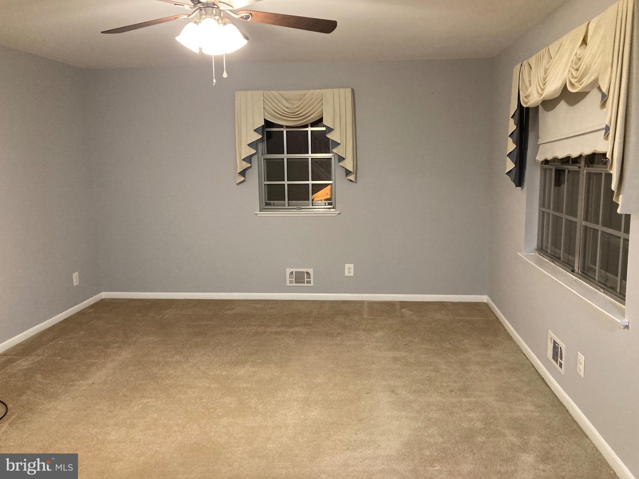 706 Crosby Road Baltimore, MD 21228 - Photo 14 of 41 an empty room with windows and fan