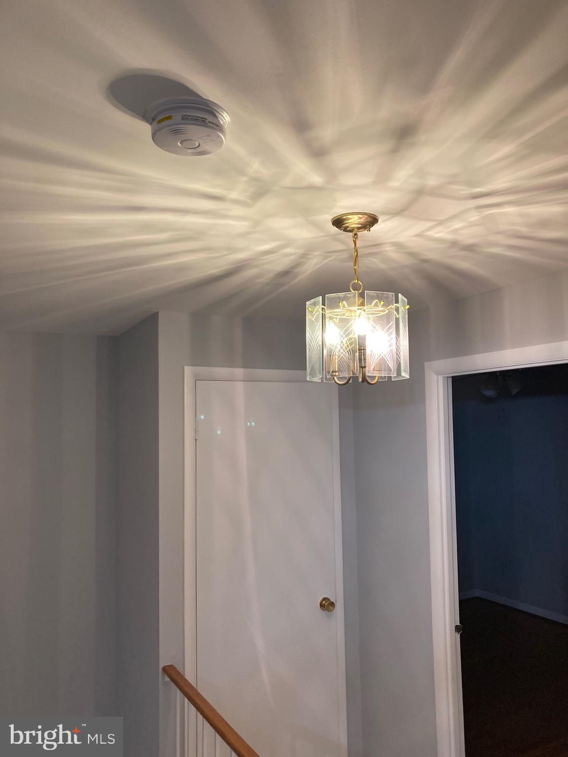 706 Crosby Road Baltimore, MD 21228 - Photo 16 of 41 a view of a hallway with windows and chandelier