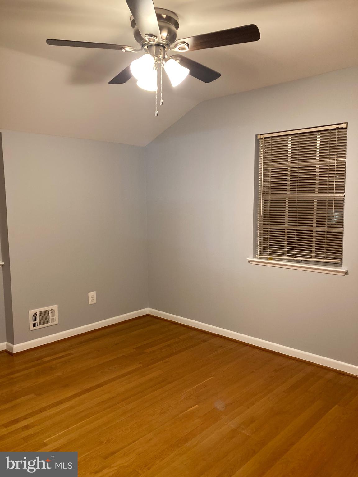 706 Crosby Road Baltimore, MD 21228 - Photo 17 of 41 an empty room with a window and a ceiling fan