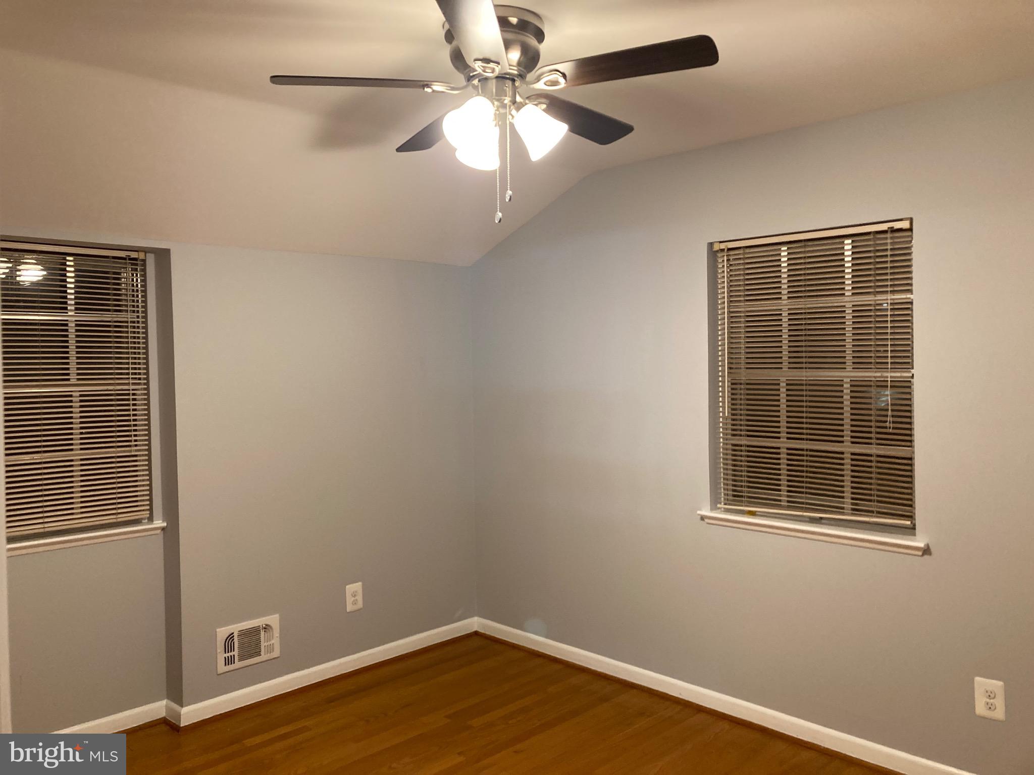 706 Crosby Road Baltimore, MD 21228 - Photo 18 of 41 an empty room with windows and fan