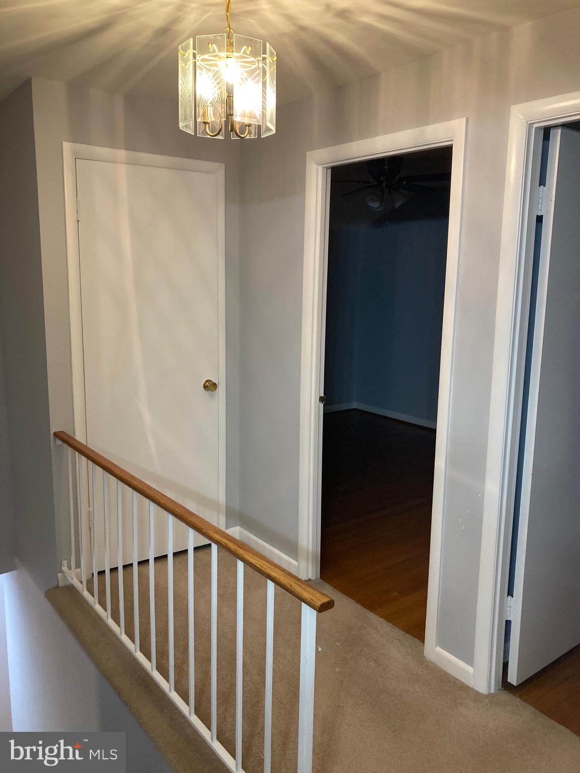 706 Crosby Road Baltimore, MD 21228 - Photo 24 of 41 a view of a hallway with windows and chandelier