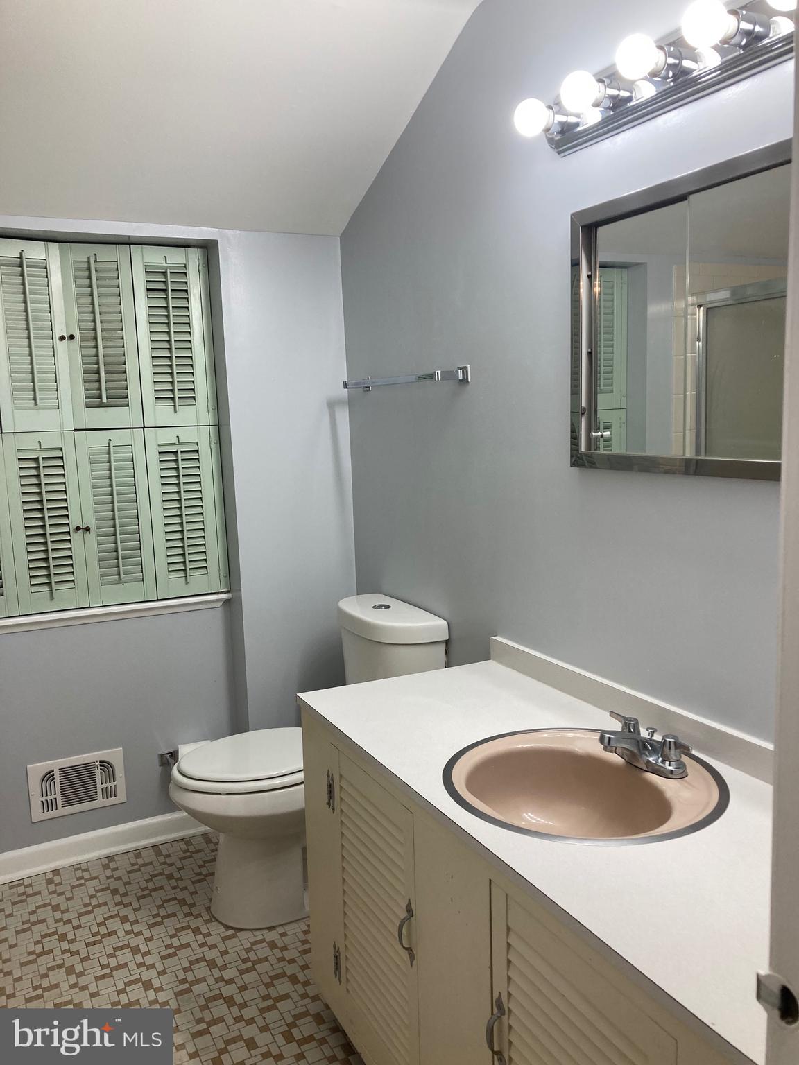 706 Crosby Road Baltimore, MD 21228 - Photo 26 of 41 a bathroom with a sink toilet and mirror