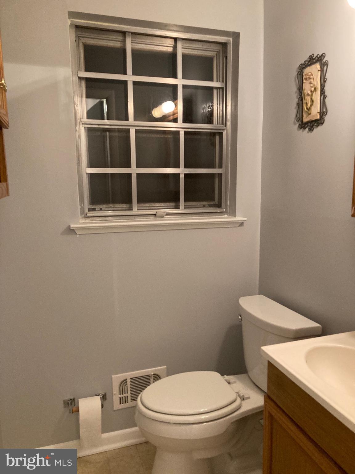 706 Crosby Road Baltimore, MD 21228 - Photo 30 of 41 a white toilet sitting next to a bathroom sink