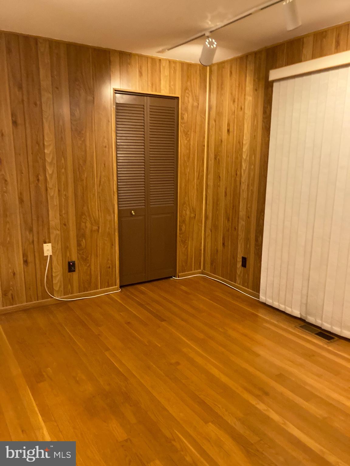 706 Crosby Road Baltimore, MD 21228 - Photo 33 of 41 a view of an empty room with wooden floor