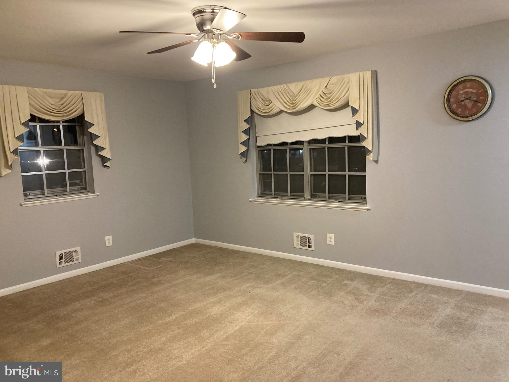 706 Crosby Road Baltimore, MD 21228 - Photo 34 of 41 an empty room with wooden floor and windows