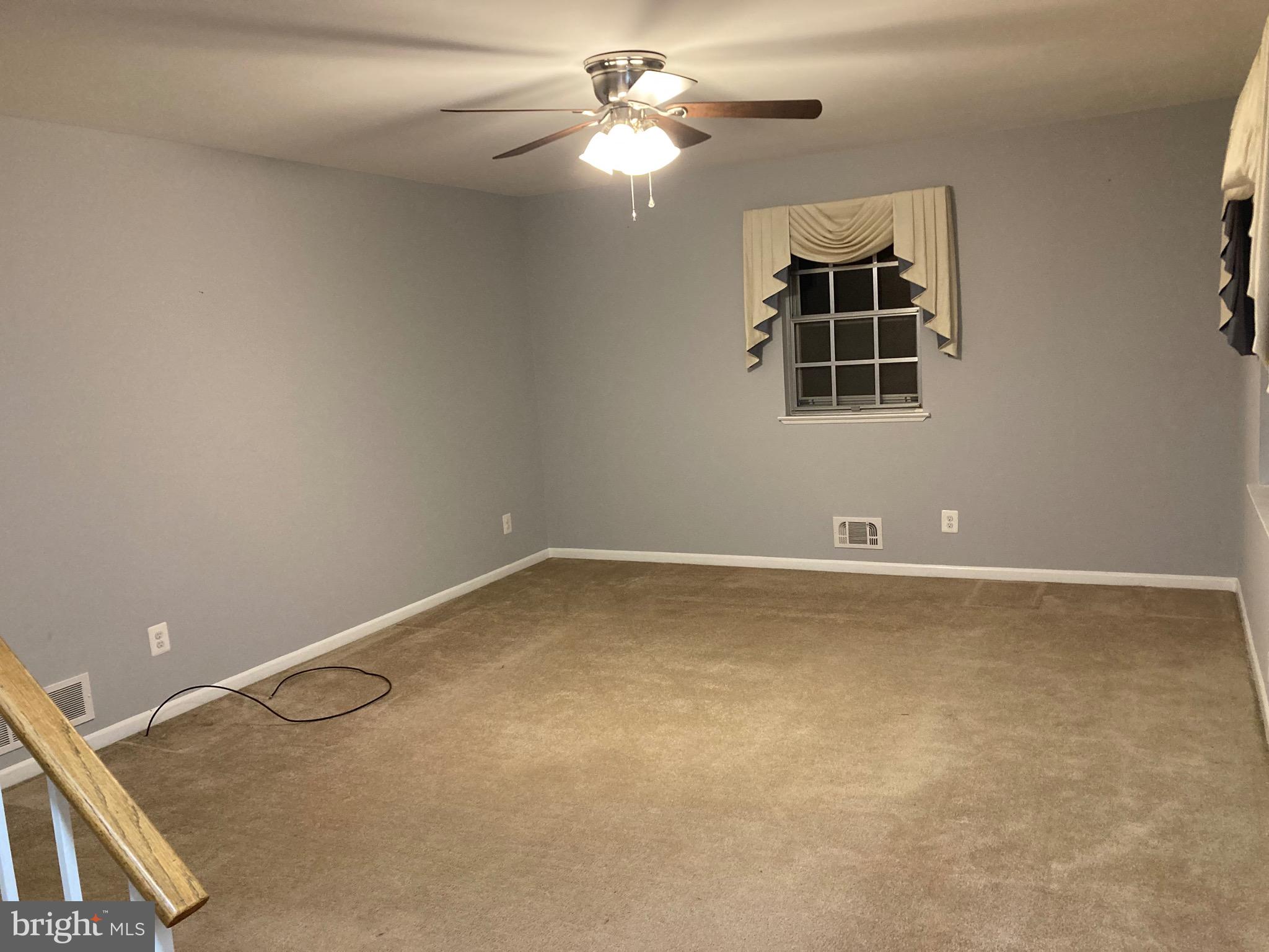 706 Crosby Road Baltimore, MD 21228 - Photo 35 of 41 a view of a room with chandelier fan and closet
