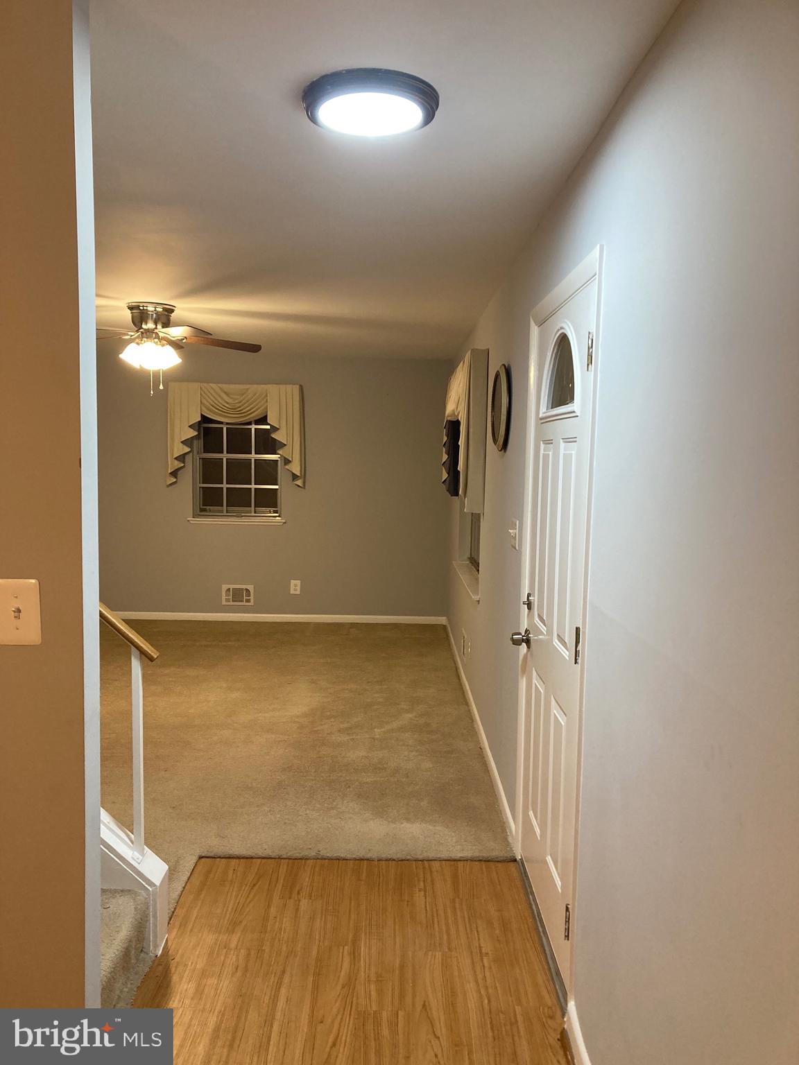 706 Crosby Road Baltimore, MD 21228 - Photo 36 of 41 a view of a hallway with wooden floor and staircase