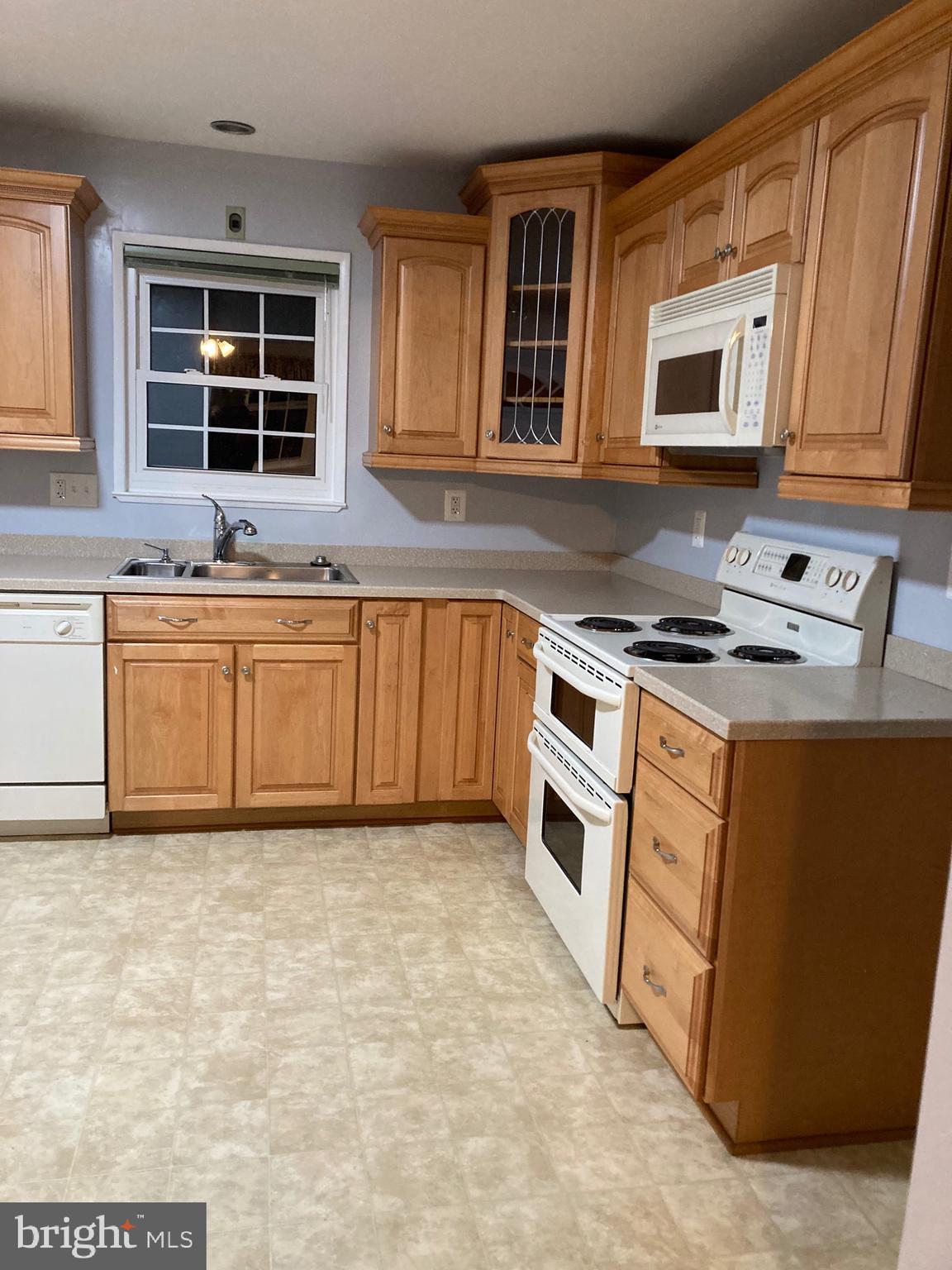 706 Crosby Road Baltimore, MD 21228 - Photo 39 of 41 a kitchen with stainless steel appliances granite countertop a stove a sink and a microwave