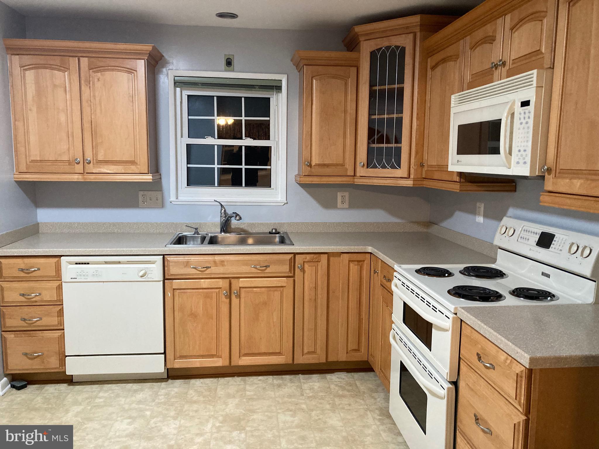 706 Crosby Road Baltimore, MD 21228 - Photo 40 of 41 a kitchen with granite countertop a sink and a stove top oven