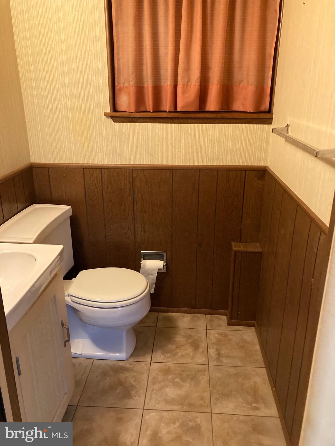 706 Crosby Road Baltimore, MD 21228 - Photo 5 of 41 a bathroom with a toilet and a sink