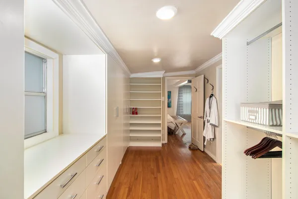 a view of walk in closet with empty racks