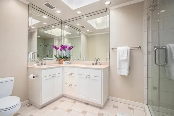 a bathroom with a sink vanity mirror and toilet
