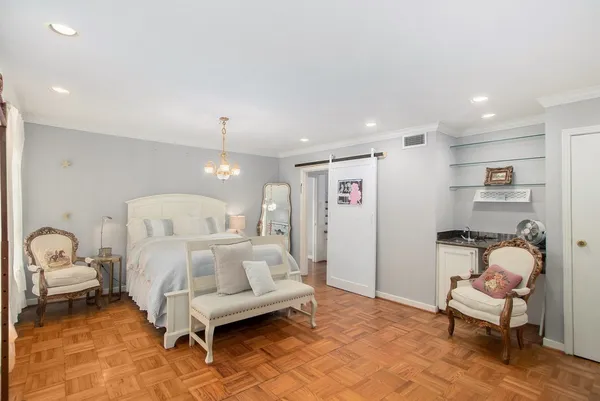 a bedroom with a bed and a chair