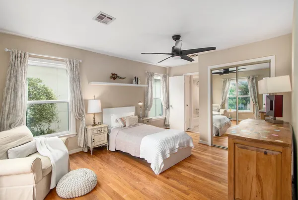 a bedroom with a bed couch and a window