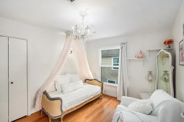 a spacious bedroom with a bed and a chandelier