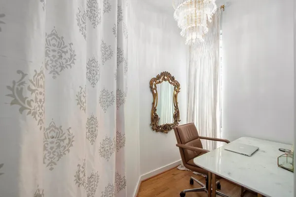a view of a dining room with furniture and chandelier