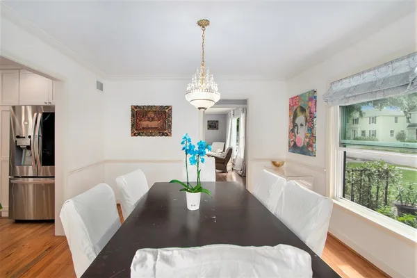 a living room with furniture dining table and a chandelier
