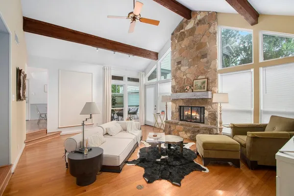 a living room with furniture large window and fireplace