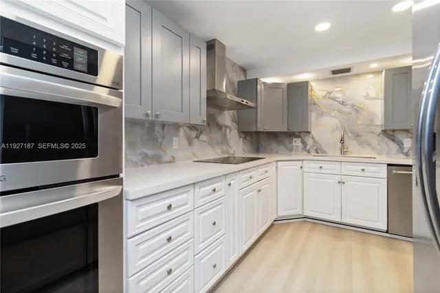 a kitchen with granite countertop cabinets stainless steel appliances and a counter space