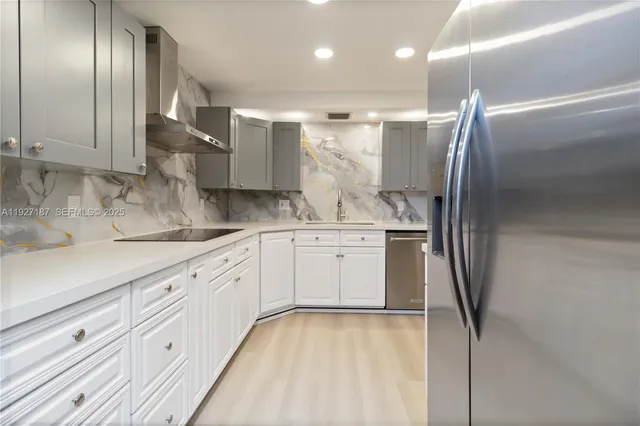 a kitchen with a refrigerator sink and cabinets
