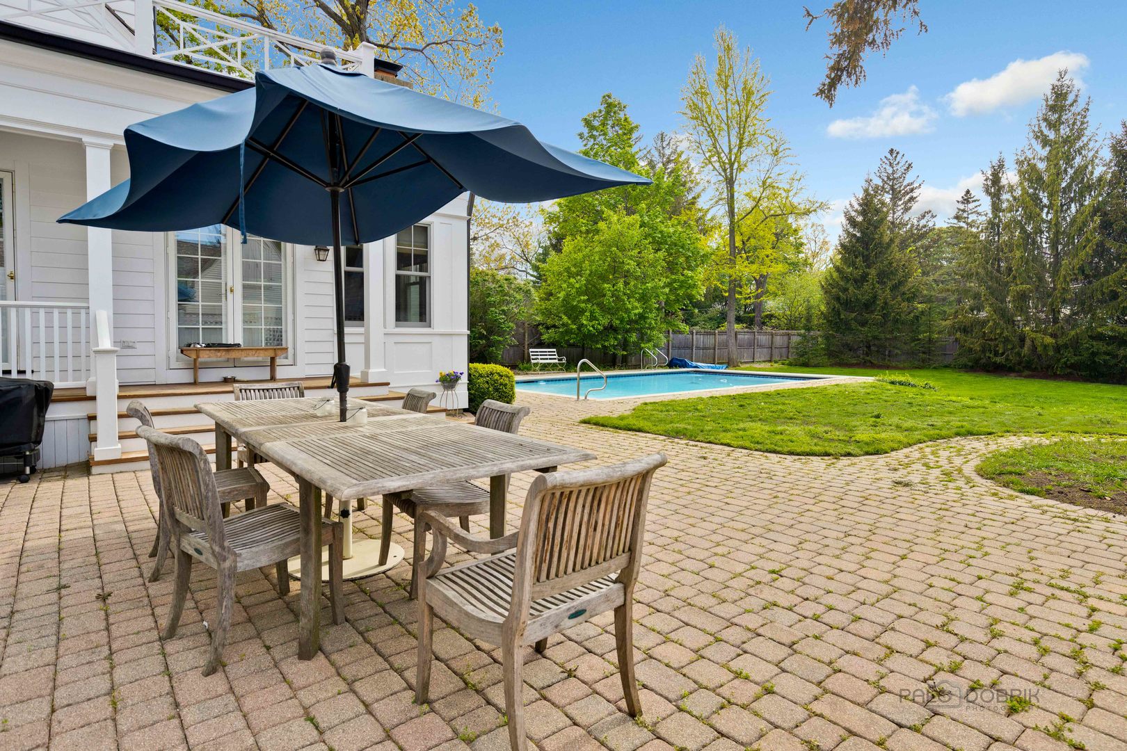224 Maple Court Lake Forest, IL 60045 - Photo 43 of 51 a patio with a table and chairs under an umbrella