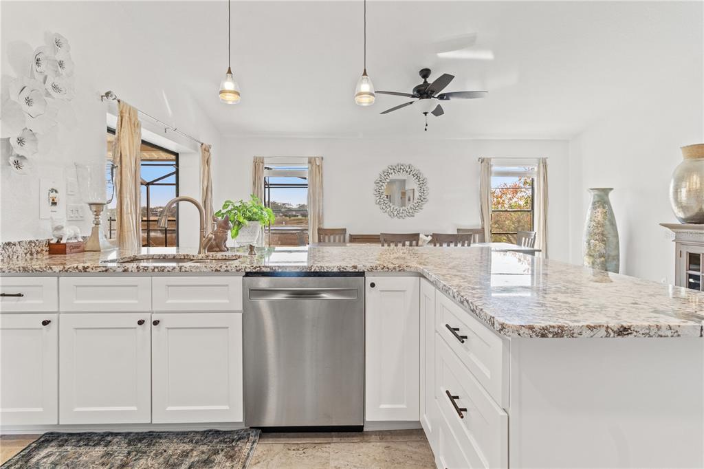 488 Fieldstone Lane Spring Hill, FL 34606 - Photo 18 of 55 a kitchen with stainless steel appliances granite countertop a sink and dishwasher with white cabinets